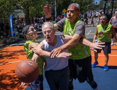 On the new Senior Court on Spokane Falls Boulevard, Terry Nealey, with team Swinging Doors, is guarded by Willie Womer, left, and Michael Jordan. This is the first year Hoopfest has set aside a special court for over-70 seniors.  (COLIN MULVANY/THE SPOKESMAN)