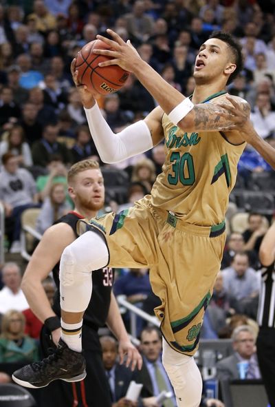 Notre Dame’s Zach Auguste, right, scored 25 points to hold back Northeastern’s upset bid. (Associated Press)