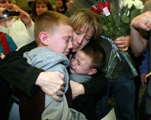 Corina Lankford hugs her sons Josef (left), 10, and David, 6, after arriving with two other church volunteers at the Boise Airport early Friday morning Feb. 19, 2010. (Joe Jaszewski / The Idaho Statesman)