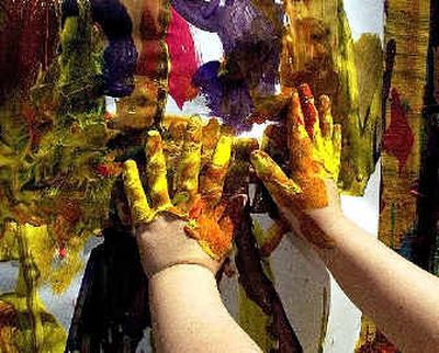 Sarah Gores, 2, skipped the brushes and used her hands to create a work of art at Artfest 2003.
(File photos/ / The Spokesman-Review)