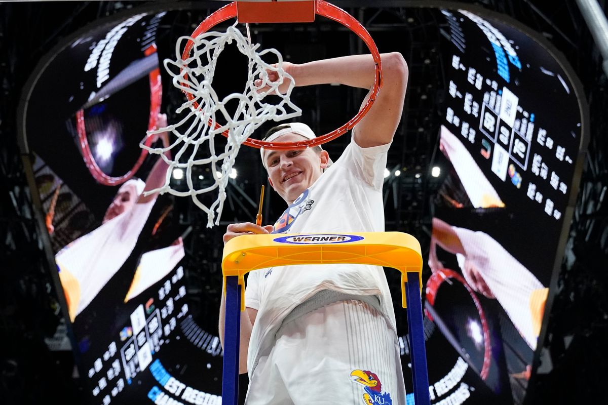 Kansas’ Mitch Lightfoot cuts down the net after his Jayhawks beat Miami in the NCAA Tournament on Sunday in Chicago.  (Nam Y. Huh)