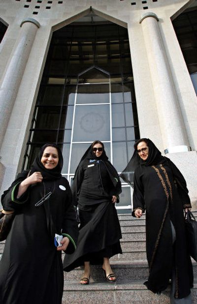 
Left to right, Amina Al Jassim, Samia Al-Edrisi and Laila Alarifi leave the Chamber of Commerce building last week in Khobar, Saudi Arabia.  
 (Associated Press / The Spokesman-Review)
