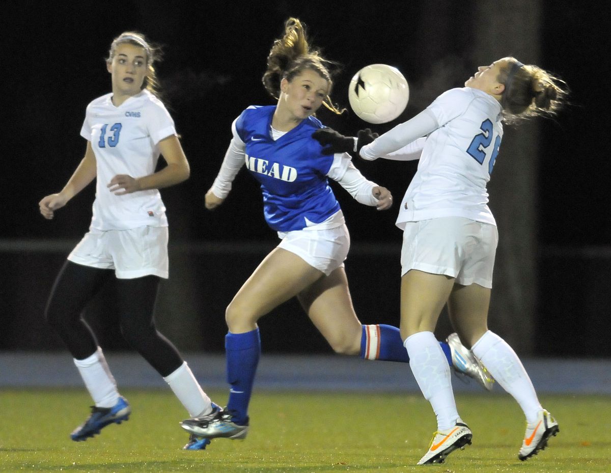 Mead’s Kathryn Imming and Central Valley’s Sara Grozdanich fight for control of the ball as CV’s Kasey Ames (13) looks on. (JESSE TINSLEY PHOTOS)