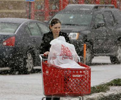 
A shopper walks back to her car after leaving a Target store in Kingston, Mass. Retailers are not seeing an uptick in sales, so consumers should expect to see more bargains as Christmas nears.Associated Press
 (Associated Press / The Spokesman-Review)