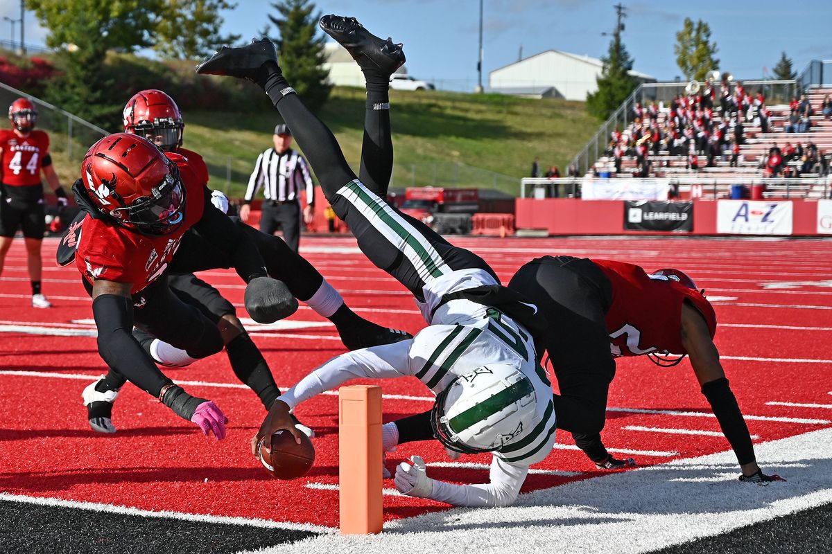 Portland State quarterback Dante Chachere dives in for a touchdown against Eastern Washington defensive back Ely Doyle, left, and defensive end Marlon Jones Jr. on Saturday.  (James Snook)