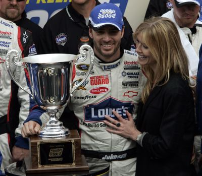 Jimmie Johnson celebrates with his wife, Chandra, after winning the Goody’s 500. (Associated Press / The Spokesman-Review)