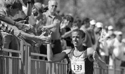 
Alan Webb takes a victory lap after winning the men's mile at the Drake Relays.
 (Associated Press / The Spokesman-Review)