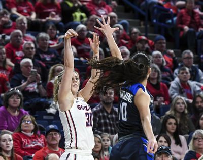 Gonzaga forward Chandler Smith nails a 3-pointer over BYU guard Malia Nawahine on  Feb. 24, 2018, in the McCarthey Athletic Center. (Dan Pelle / The Spokesman-Review)