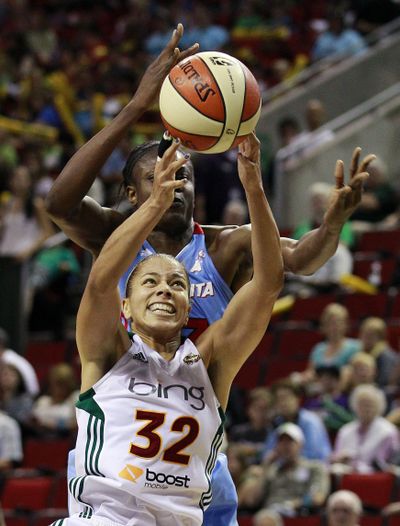Alysha Clark (32) controls a loose ball for the Seattle Storm. (Associated Press)