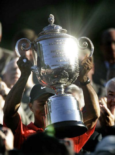 
Tiger Woods holds the Wanamaker Trophy after winning the 88th PGA Championship golf tournament. 
 (Associated Press / The Spokesman-Review)