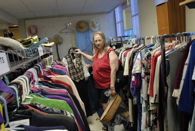 Teresa Gibson shows a friend an outfit that she needs for an upcoming special occasion at the Valley Partners Clothing Bank.  (J. BART RAYNIAK / The Spokesman-Review)