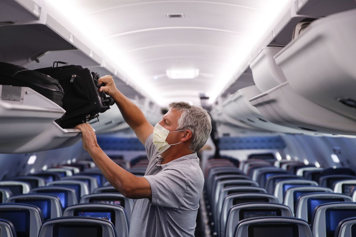 A passenger wears personal protective equipment on a Delta Airlines flight after landing May 28 at Minneapolis−Saint Paul International Airport.  (Associate Press)