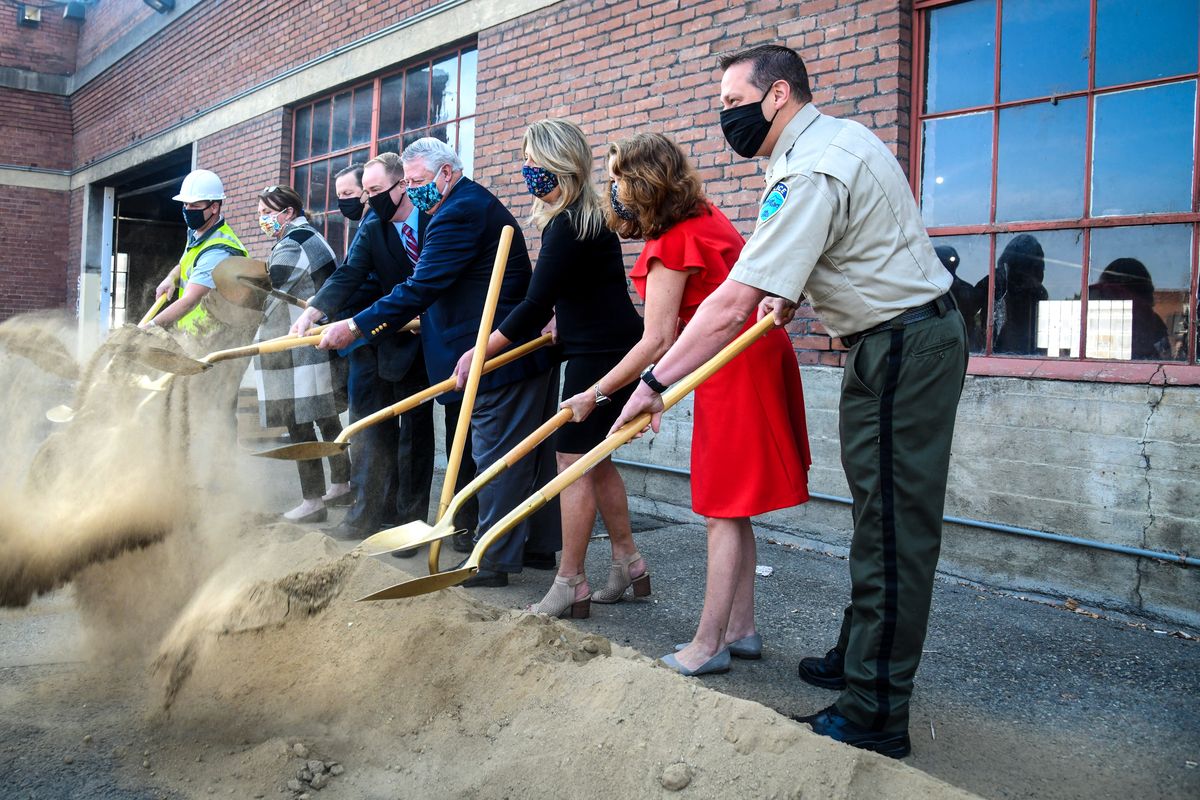 From left, Paul Riener, project manager form Baker Construction; Nancy Isserlis, board member at Pioneer Human Services; Spokane Councilman Breean Beggs; County Commissioners Josh Kerns and Al French; Spokane Mayor Nadine Woodward; County Commissioner Mary Kuney and Spokane Valley Police Chief Dave Ellis kick up shovels of dirt Friday for the groundbreaking of the Mental Health Crisis Stabilization Facility on the 1300 block of West Gardner.  (DAN PELLE/THE SPOKESMAN-REVIEW)