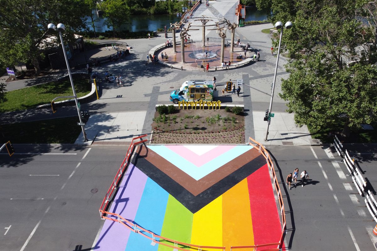 The intersection of Spokane Falls Boulevard and Howard Street, just outside Riverfront Park, has been filled with a mix of colored panels that have meaning for people in the LGBTQ+ community as a preparation for the Pride Parade next weekend in downtown Spokane. A group of volunteers pitched in to paint the street Sunday.  (Jesse Tinsley/THE SPOKESMAN-REVIEW)