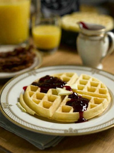 
A crisp, golden homemade waffle, served with hot raspberry sauce, makes a delicious breakfast. 
 (Associated Press / The Spokesman-Review)