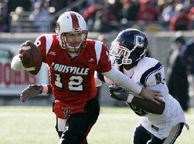 
Louisville quarterback Brian Brohm tries to avoid a tackle by Connecticut's Lindsey Witten. 
 (Associated Press / The Spokesman-Review)