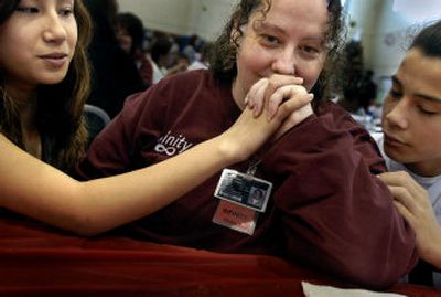 
Kerry Perez cries as she spends time with her daughter, 14-year-old Tomarro Stackhouse, left,  and her son, Jonny Stackhouse, 16, at the Pine Lodge Corrections Center in Medical Lake. 
 (Jed Conklin / The Spokesman-Review)