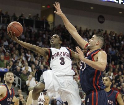Gonzaga's Demetri Goodson (3) drives to the basket against Saint Mary's Omar Samhan during the first half of the West Coast Conference men's tournament championship NCAA college basketball game in Las Vegas tonight. (The Spokesman-Review)