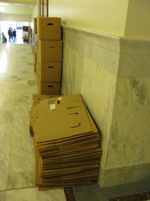 Boxes are stacked in the hallway in the Garden Level of the state capitol, but a brief flurry of hope Thursday that the legislative session could be wrapped up by Friday was dashed by the end of the day, with both House and Senate leaders conceding they'll likely be back on Monday. (Betsy Russell)