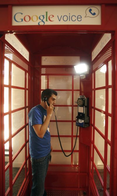 Jason Toff, marketing manager for Google Voice, demonstrates how to make a call from a phone booth at the Google office in San Francisco. Google plans to make Web phone calls available to Gmail users within the next few days.  (Associated Press)