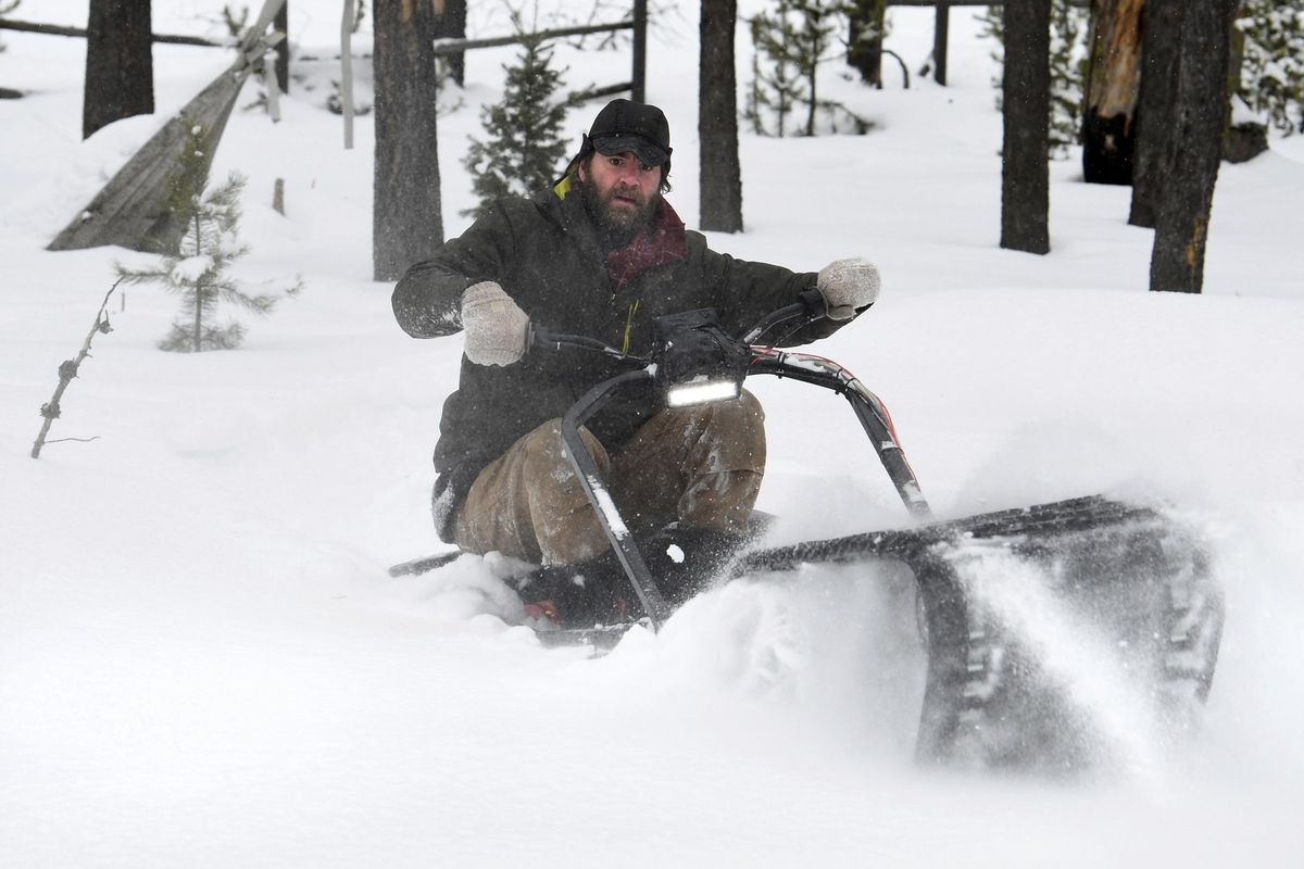Inventor August Lockwood breaks through the snow near his home while riding his electric "snow track" machine in Seeley Lake, Mont. (Kurt Wilson / Associated Press)