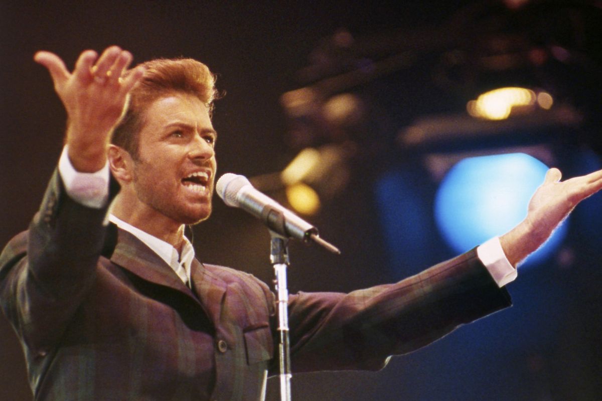 In this Dec. 2, 1993 file photo, George Michael performs at “Concert of Hope” to mark World AIDS Day at London’s Wembley Arena. Listen to George Michael’s jazz ballad “Kissing a Fool” in honor of April Fool’s Day. (Gill Allen / Associated Press)