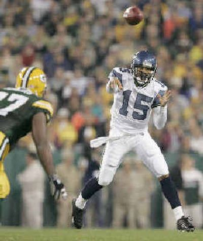 
Seahawks QB Seneca Wallace (15) passes downfield as Packers defensive tackle Cullen Jenkins pursues.
 (Associated Press / The Spokesman-Review)