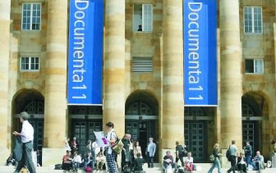 
People stand and walk in front of the municipal hall of Kassel, Germany. Documenta, a major contemporary art event, is held every five years. 
 (Associated Press / The Spokesman-Review)