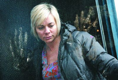 
Nichole Burrell leaves her home at 17 N. Cedar St in Peaceful Valley on Wednesday as the muddy handprints of a man who banged on her door early Monday morning are still visible. The man, Shonto K. Pete, was at the door searching for help after he had been shot in the head by off-duty Spokane police Officer James Olsen. 
 (Photos by Jed Conklin / The Spokesman-Review)
