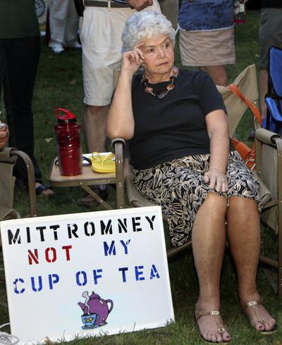 Ann Kalifrath listens to Republican presidential candidate Mitt Romney speak at a Tea Party Express rally last month in Concord, N.H. (Associated Press)