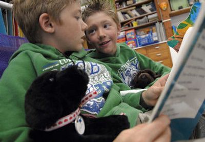 
Bryan Elementary first-grader Colten Melton, left reads with his brother Dakota Melton, second grade. 
 (Kathy Plonka / The Spokesman-Review)