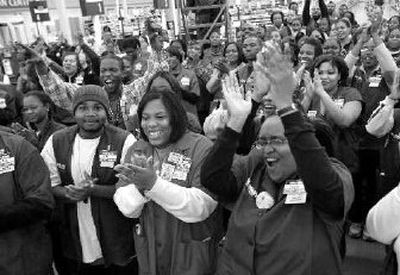 
Wal-Mart employees cheer during a rally as they prepare for the opening of their new store last year near Chicago. 
 (Associated Press / The Spokesman-Review)