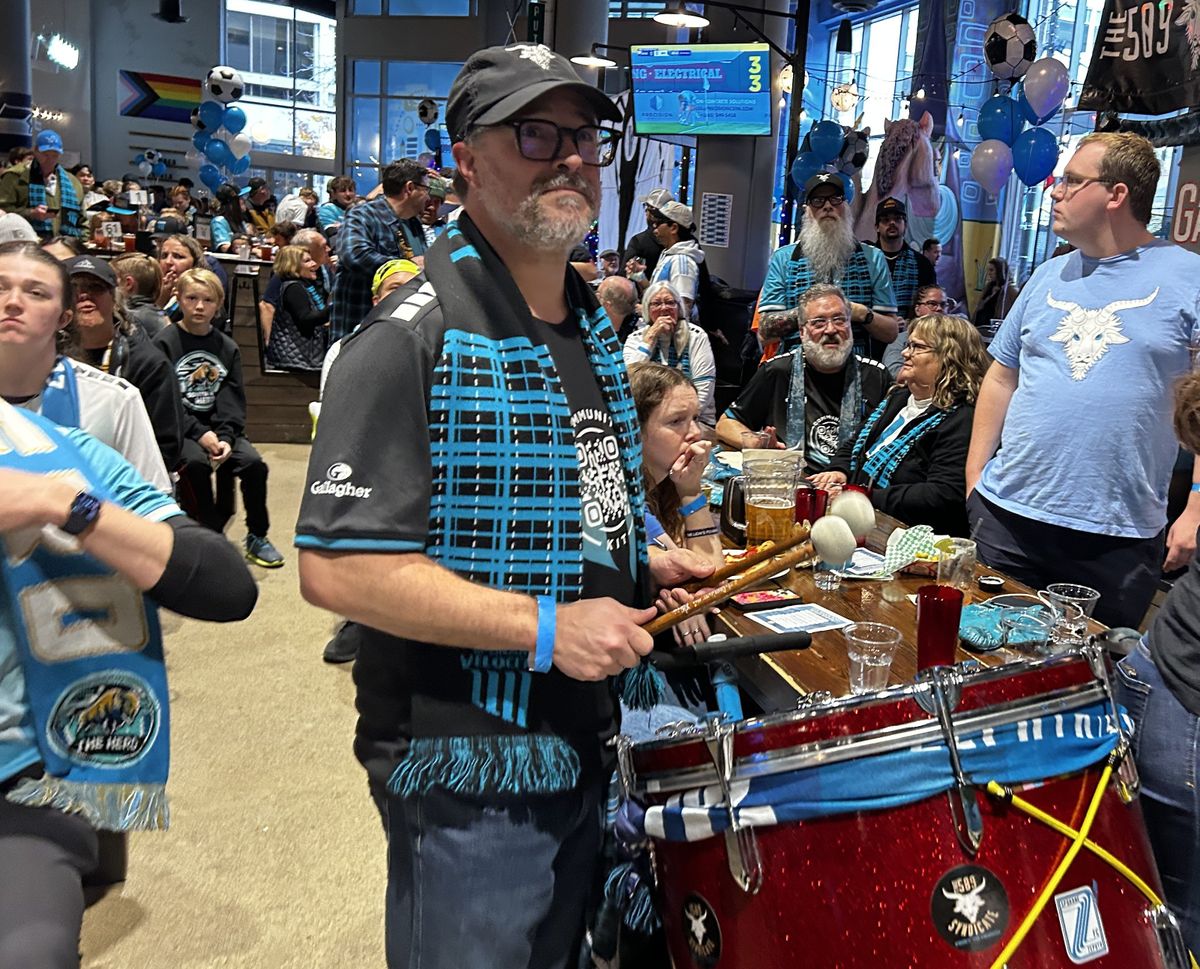 Loren Baker plays the bass drum at a watch party during the first half of the championship match on Sunday afternoon. Spokane Velocity FC faced One Knoxville SC, losing 2-0. (Emily White/The Spokesman-Review)