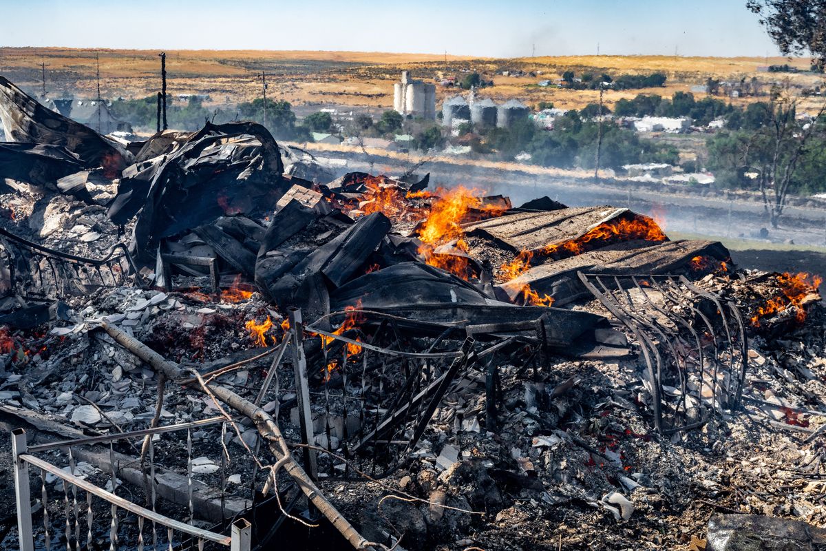 A mobile home on the south side of the Adams County town of Lind, Wash., was destroyed by a wildfire Thursday. The Adams County Sheriff’s Office reported six homes were destroyed in the blaze.  (COLIN MULVANY/THE SPOKESMAN-REVIEW)