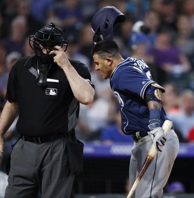 San Diego Padres’ Manny Machado, right, throws down his helmet as he yells at home plate umpire Bill Welke, who had called Machado out on strikes during the fifth inning of the team’s baseball game against the Colorado Rockies on Saturday, June 15, 2019, in Denver. (David Zalubowski / Associated Press)