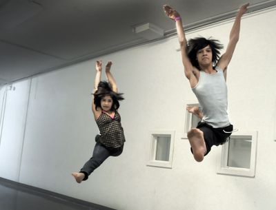 Eilis Smith and Christian Brower  work on a leap during a rehearsal at Dance Emporium last week. Smith and Brower  are two of 45 dancers selected from thoughout the United States for a summer intensive program that will take them to California and then China to learn and perform.  (CHRISTOPHER ANDERSON / The Spokesman-Review)