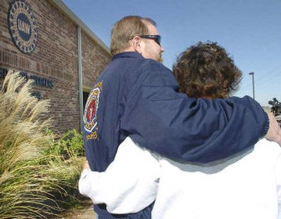 
Tim O'Connor, left, president of Central Oklahoma Labor Federation, hugs UAW Local 1999 financial secretary Judy Calhoun, as they listen to a news conference at the UAW Local headquarters in Oklahoma City on Monday. The General Motors Oklahoma City Assembly plant will be closing. 
 (Associated Press / The Spokesman-Review)
