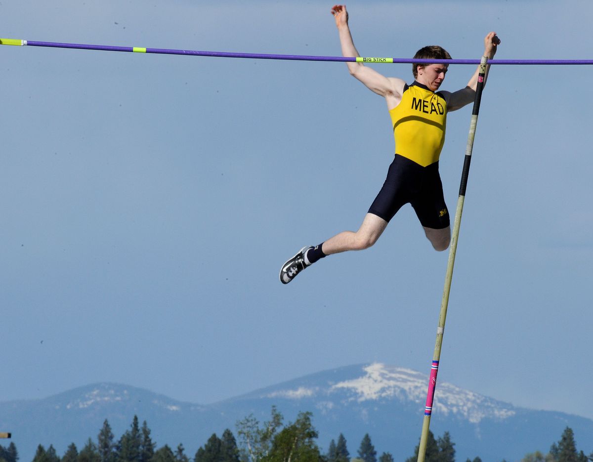 Mead’s Blasé Neumann clears the bar in the pole vault at Spokane Falls Community College. He won at 14 feet, 6 inches. (Tyler Tjomsland)
