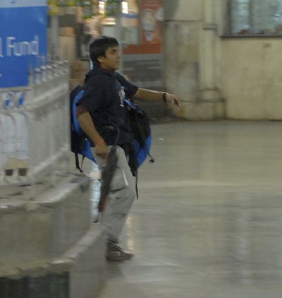 Mohammed Ajmal Kasab walks through the Chatrapathi Sivaji Terminal railway station  on Nov. 26 during an attack on Mumbai, India.  (File Associated Press / The Spokesman-Review)