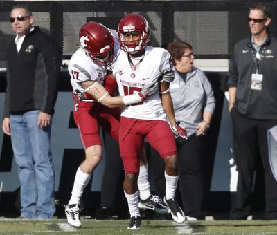 Washington State wide receiver Kyle Sweet, left, congratulates wide receiver Robert Lewis after his touchdown reception against Colorado during the first half  Nov. 19, 2016, in Boulder, Colorado. (David Zalubowski / AP)