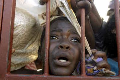 
A boy cries as he tries to get food as it's distributed Thursday at the Saint Francois D'assis church in Gonaives. 
 (Associated Press / The Spokesman-Review)