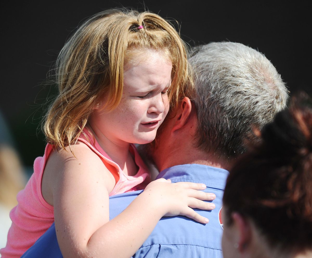 Lilly Chapman, 8, cries after being reunited with her father, John Chapman at Oakdale Baptist Church on Wednesday, Sept. 28, 2016, in Townville, S.C. Students were evacuated to the church following a shooting at Townville Elementary School. A teenager opened fire at a South Carolina elementary school on Wednesday. (Rainier Ehrhardt / Associated Press)