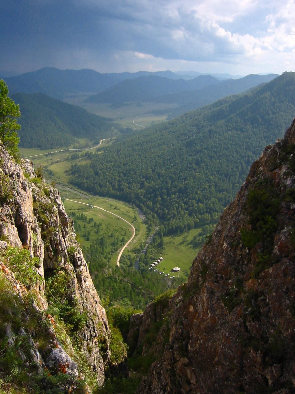 This undated photo provided by Bence Viola of the University of Toronto in August 2018 shows the valley above a cave where Denisovan fossils were found in the Altai Krai area of Russia. On Wednesday, Aug. 22, 2018, scientists reported in the journal Nature that they have found the remains of an ancient female whose mother was a Neanderthal and whose father belonged to another extinct group of human relatives known as Denisovans. (Bence Viola / AP)