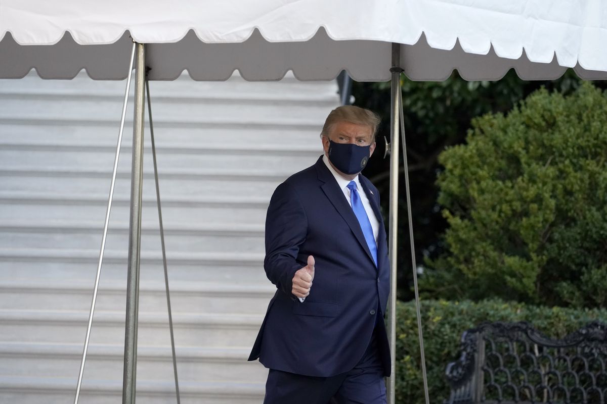 President Donald Trump gives a thumbs-up as he leaves the White House to go to Walter Reed National Military Medical Center after he tested positive for COVID-19, Friday, Oct. 2, 2020, in Washington.  (Alex Brandon)