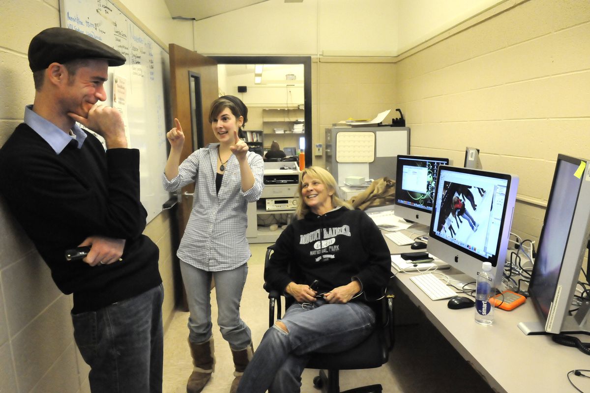 Faculty adviser Jason Nix, left, and students Kaitlin Allen and Deby Dixon talk about a photo near a bank of state-of-the-art computers used to produce the student newspaper, the Communicator, at Spokane Falls Community College.  (Jesse Tinsley)