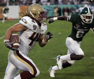 
Boston College safety Jamie Silva runs past Mark Dell with one of two interceptions that helped earn Silva the Champ Sports Bowl MVP.  Associated Press
 (Associated Press / The Spokesman-Review)