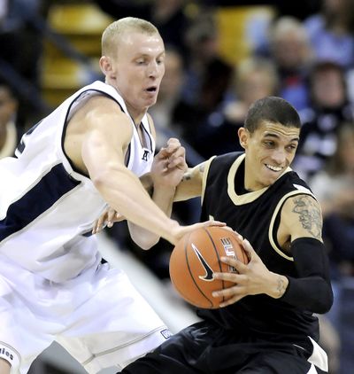 Utah State forward Brady Jardine, left, reaches around to steal the ball from Idaho guard Steffan Johnson during their game Wednesday February 3, 2010 in Logan Utah. (Eli Lucero / The Herald Journal)