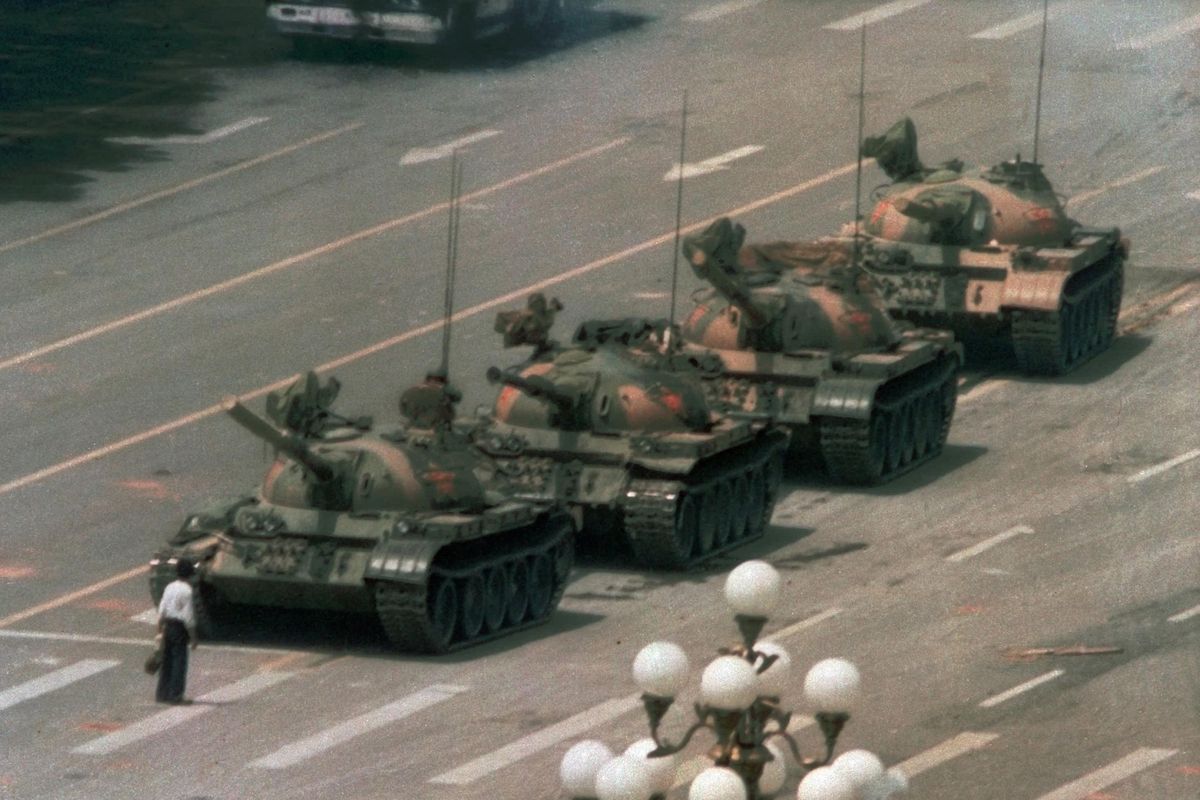 In this June 5, 1989, photo, a Chinese man stands alone to block a line of tanks heading east on Beijing’s Changan Blvd. in Tiananmen Square. (Jeff Widener / Associated Press)