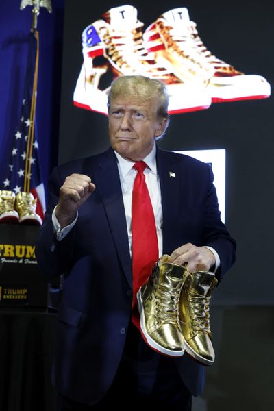 Republican presidential candidate and former President Donald Trump holds a pair of his new line of signature shoes after taking the stage at Sneaker Con at the Philadelphia Convention Center on Saturday in Philadelphia.  (Chip Somodevilla)