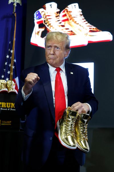 Republican presidential candidate and former President Donald Trump holds a pair of his new line of signature shoes after taking the stage at Sneaker Con at the Philadelphia Convention Center on Saturday in Philadelphia.  (Chip Somodevilla)